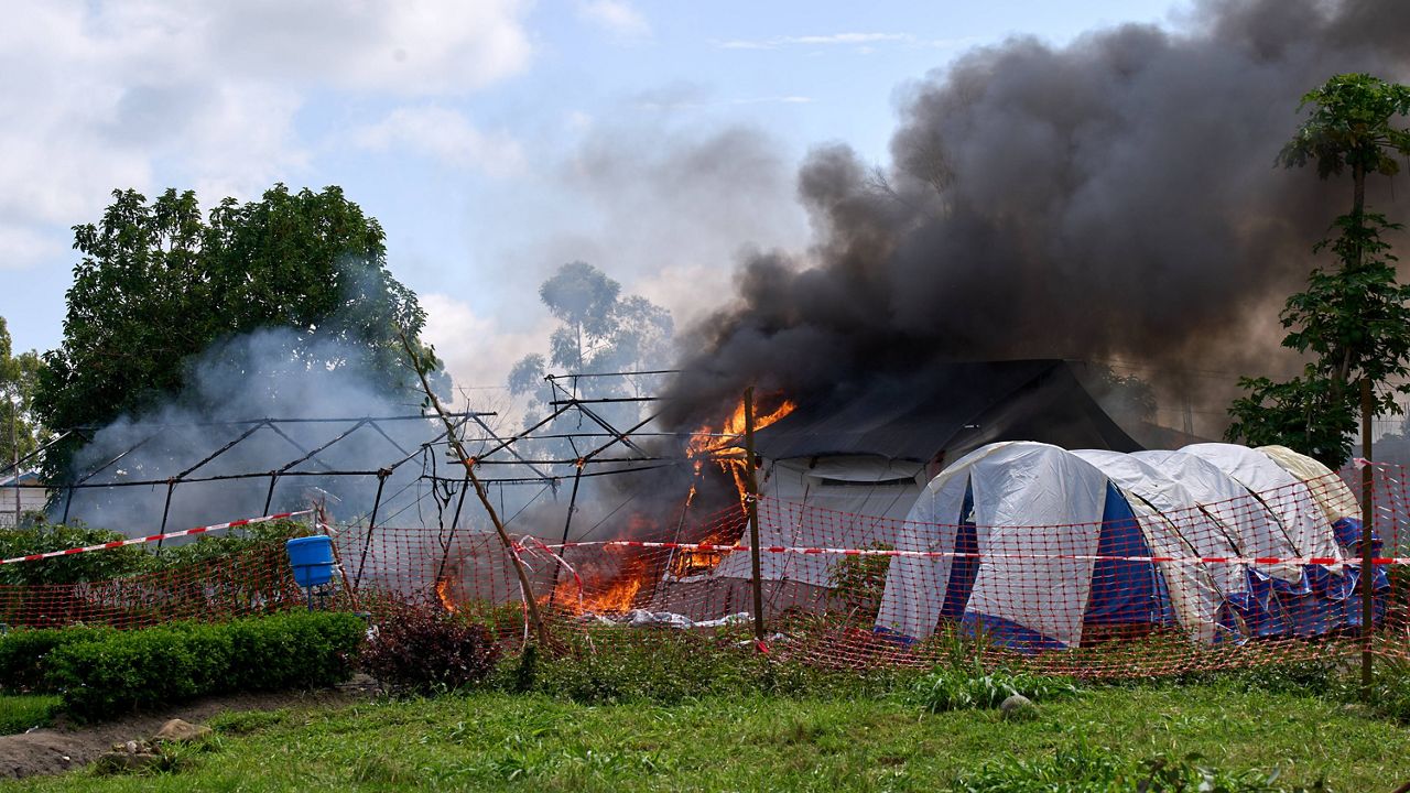 Flames and smoke rise from an Ebola treatment center in Rwampara, Congo, Thursday, May 21, 2026. (AP Photo/Dirole Lotsima Dieudonne)