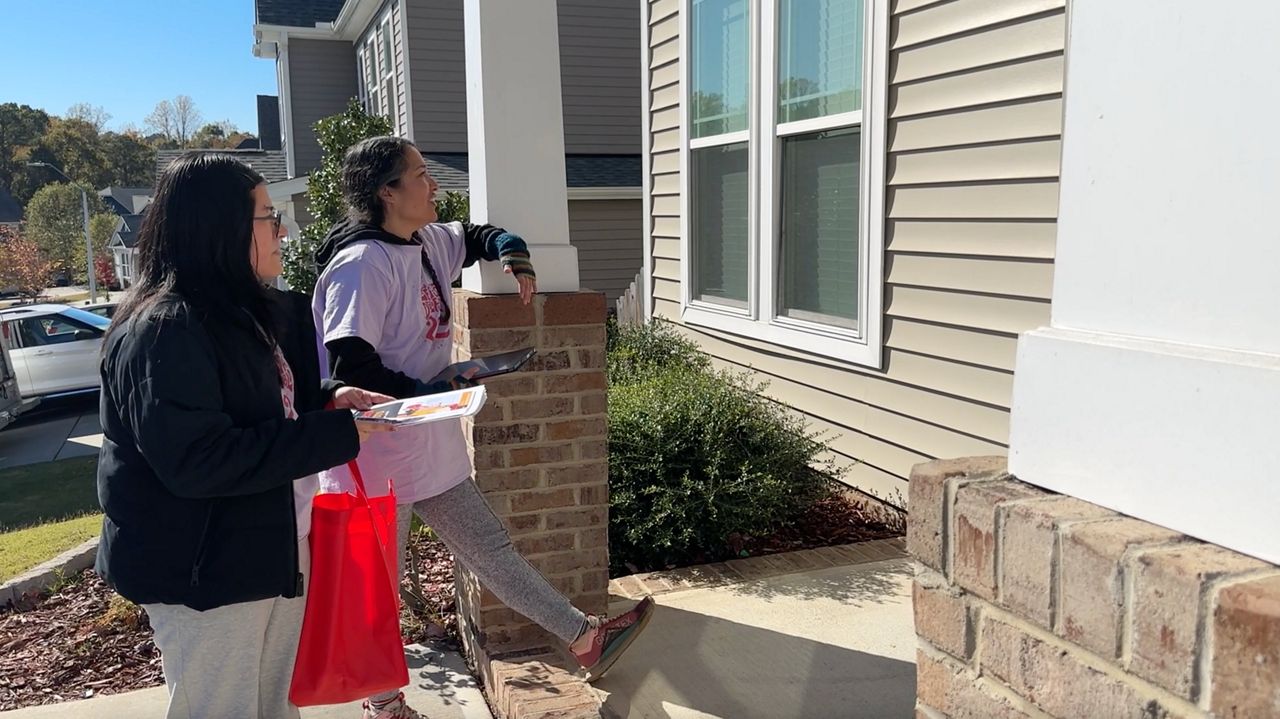 El Pueblo volunteers talking with a resident in Knightdale.