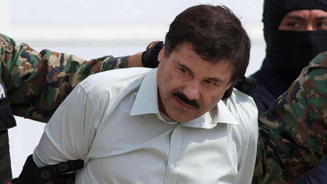 This Feb. 22, 2014 file photo shows Joaquin "El Chapo" Guzman, the head of Mexico's Sinaloa Cartel, being escorted to a helicopter in Mexico City following his capture overnight in the beach resort town of Mazatlan, Mexico. With Sinaloa cartel boss Joaquín “El Chapo” Guzmán serving a life sentence, his sons steered the family business into fentanyl, establishing a network of labs churning out massive quantities they smuggled into the U.S., prosecutors in the U.S. revealed in an indictment unsealed April 14, 2023 in Manhattan. (AP Photo/Eduardo Verdugo, File)