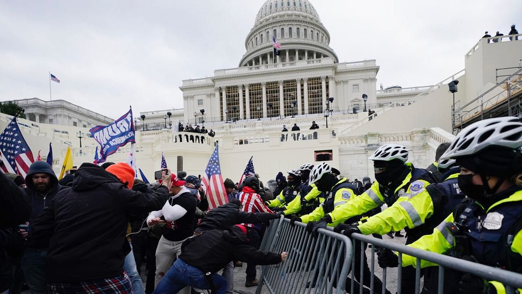 Violent insurrectionists loyal to then-President Donald Trump try to break through a police barrier, Wednesday, Jan. 6, 2021, at the Capitol in Washington. (AP Photo/Julio Cortez, File)