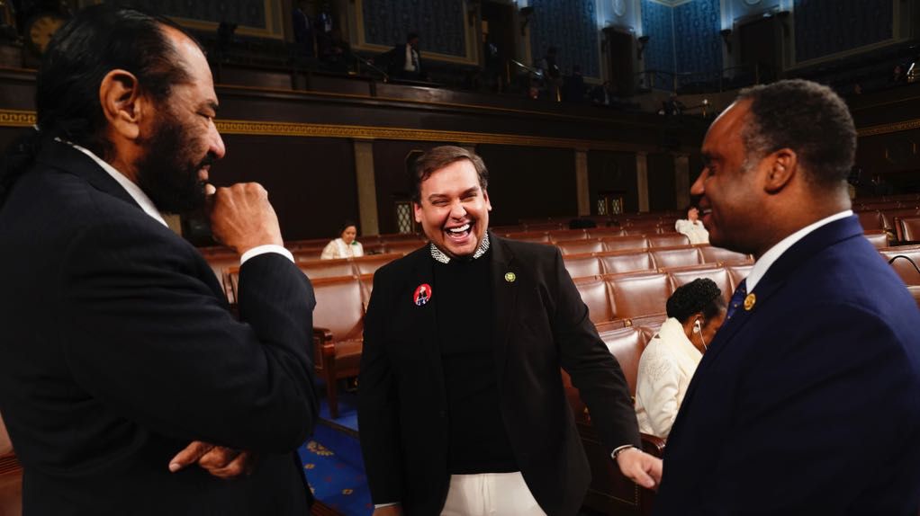Former Rep. George Santos, R-N.Y., center, talks with Rep. Al Green, D-Texas, left,and Rep. Joe Neguse, D-Colo., before President Joe Biden delivers the State of the Union address to a joint session of Congress at the Capitol, Thursday, March 7, 2024, in Washington. (Shawn Thew/Pool via AP, File)