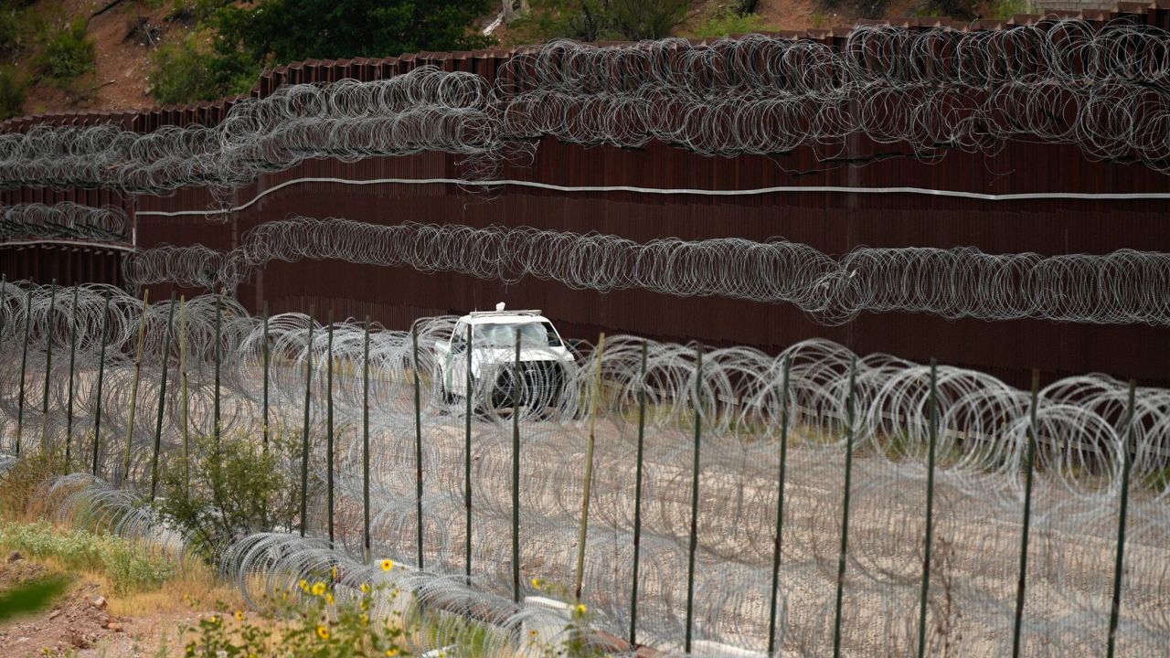 A vehicle drives along the U.S. side of the US-Mexico border wall in Nogales, Ariz., on June 25, 2024. (AP Photo/Jae C. Hong, Pool, File)