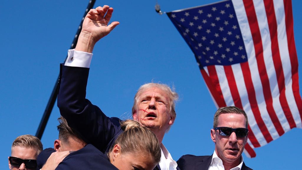 Republican presidential candidate former President Donald Trump is surrounded by U.S. Secret Service agents at a campaign rally, Saturday, July 13, 2024, in Butler, Pa. (AP Photo/Evan Vucci)