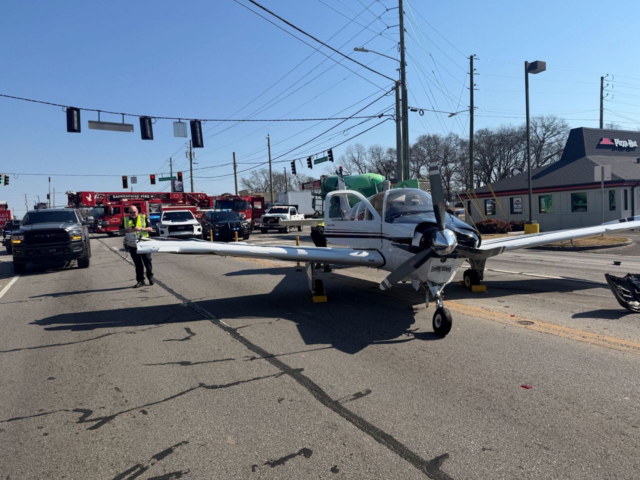 Small plane makes emergency landing on a busy Georgia road and strikes ...