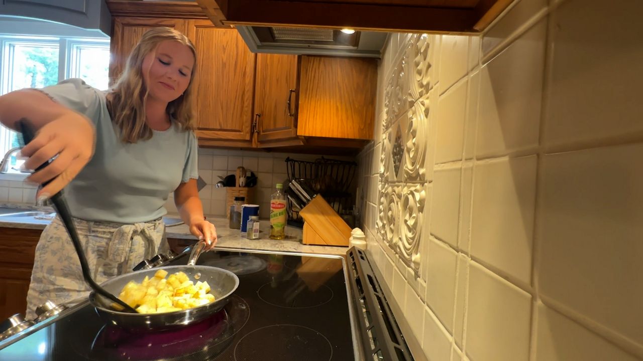 Gracelyn Eberwine cooks some potatoes in her kitchen (Spectrum News 1/Katie Kapusta)