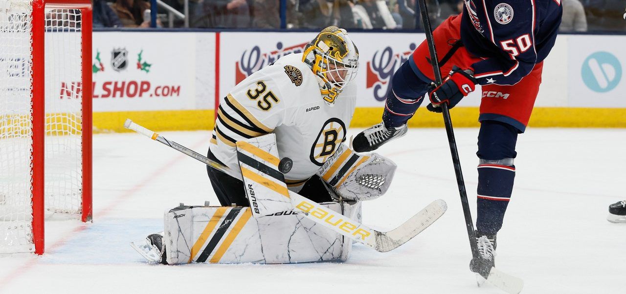 Boston Bruins' Linus Ullmark, left, makes a save against Columbus Blue Jackets' Eric Robinson, right, during the second period of an NHL hockey game Monday, Nov. 27, 2023, in Columbus, Ohio. (AP Photo/Jay LaPrete)