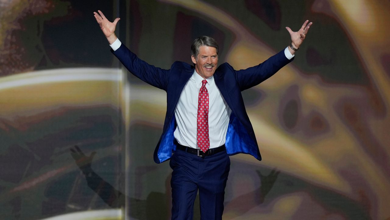 Eric Hovde raises his arms as he takes the stage during the second day of the Republican National Convention, Tuesday, July 16, 2024, in Milwaukee. (AP Photo/J. Scott Applewhite)