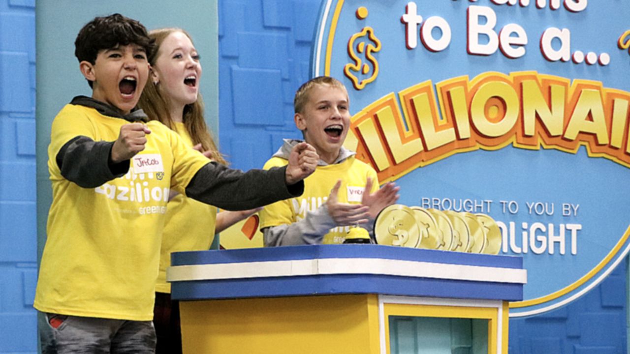 Rockwood Valley Middle School students celebrate their win during the “Who Wants to be a Bazillionaire?” game show on Wednesday, April 3. While playing games, students learned about financial literacy. (Spectrum News/Elizabeth Barmeier)