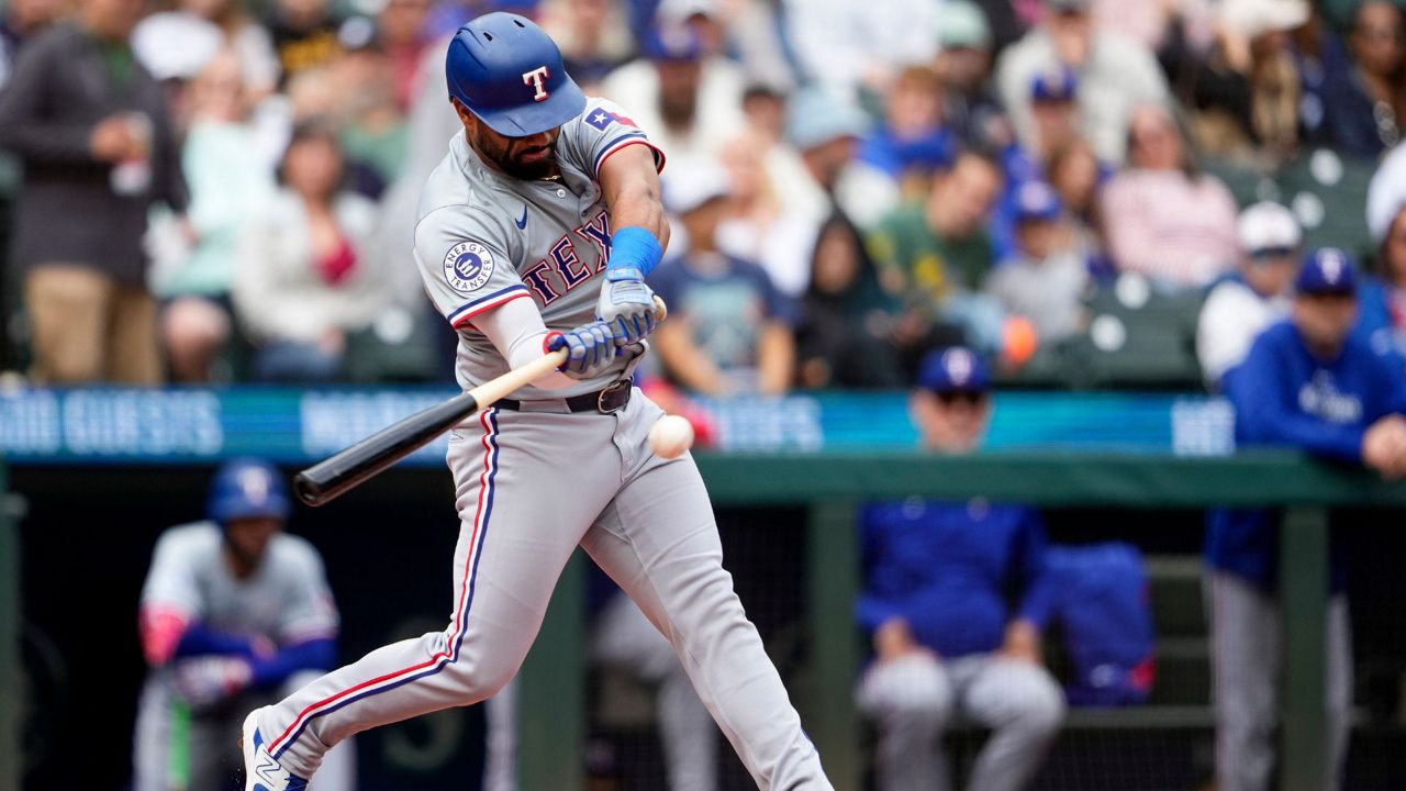 Texas Rangers' Ezequiel Duran hits a single against the Seattle Mariners during the second inning of a baseball game Sunday, Sept. 15, 2024, in Seattle. (AP Photo/Lindsey Wasson)