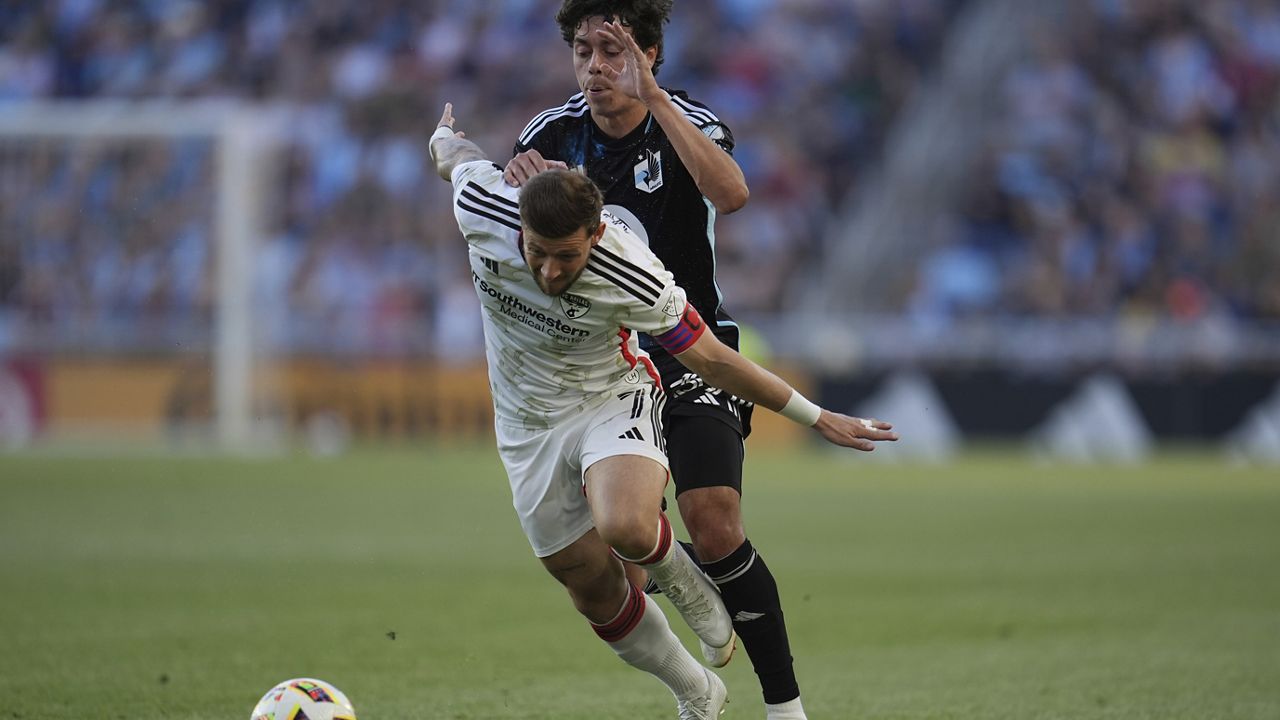 FC Dallas forward Paul Arriola, front, and Minnesota United midfielder Caden Clark battle for possession of the ball during the first half of an MLS soccer match. (AP Photo/Abbie Parr)