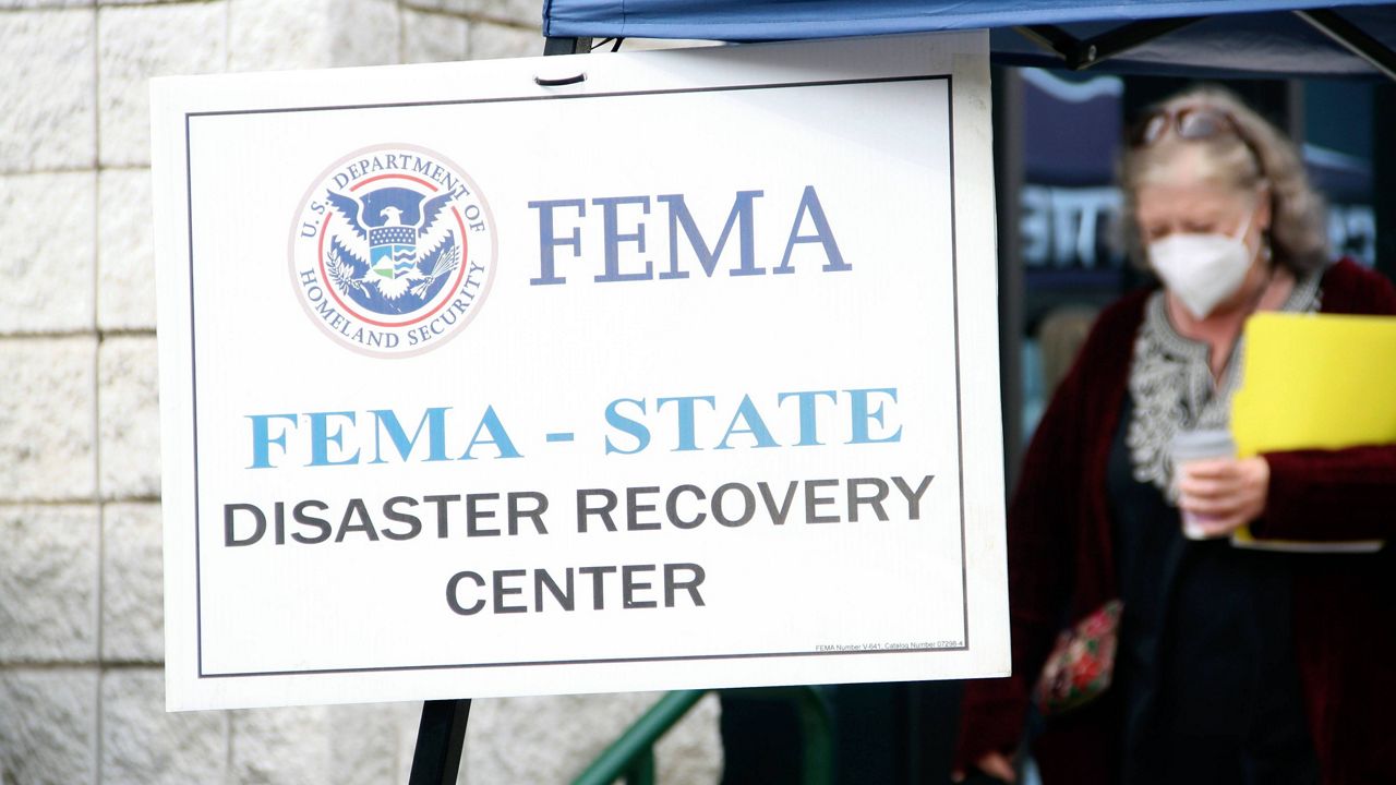 People gather at a FEMA Disaster Recovery Center at A.C. Reynolds High School in Asheville, N.C.,, Tuesday, Oct. 15, 2024. (AP Photo/Makiya Seminera)