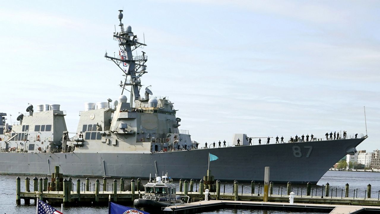 FILE - The USS Mason, an Arleigh Burke-class destroyer, passes a dock in Norfolk, Va., April 8, 2021. Officials said the USS Mason shot down a suspected Houthi drone flying in its direction during an incident in which two missiles fired from territory held by Yemen's Houthi rebels missed a commercial tanker loaded with jet fuel near the key Bab el-Mandeb Strait on Wednesday. (AP Photo/Steve Helber)