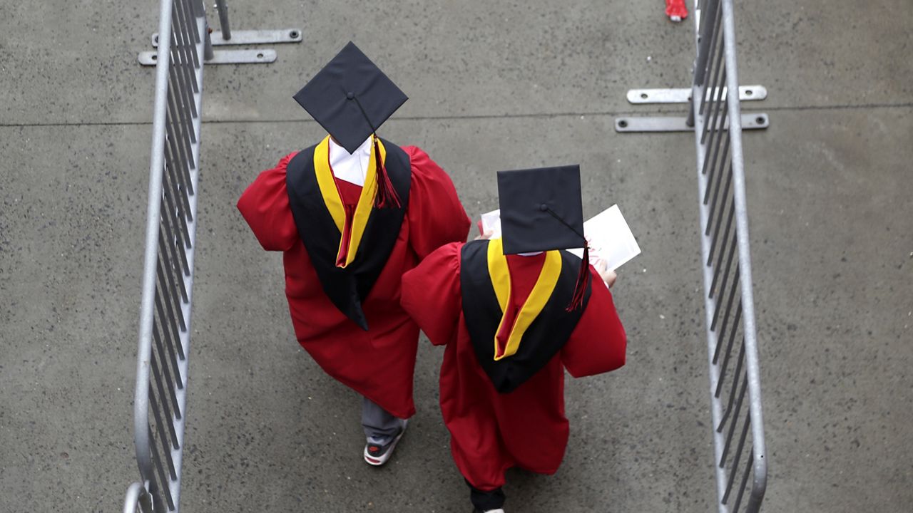 Graduates walk into High Point Solutions Stadium before the start of the Rutgers University graduation ceremony in Piscataway Township, N.J., on May 13, 2018. (AP Photo/Seth Wenig, File)