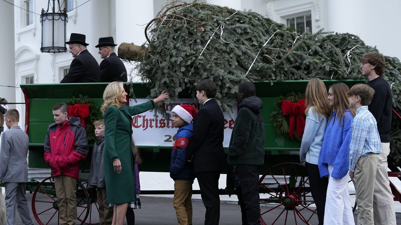 First lady Jill Biden receives the official 2023 White House Christmas Tree at the White House at the White House in Washington, Monday, Nov. 20, 2023. The tree is an 18-and-a-half-foot tall Native True fir from Cline Church Nursery in Fleetwood, N.C. (AP Photo/Susan Walsh)
