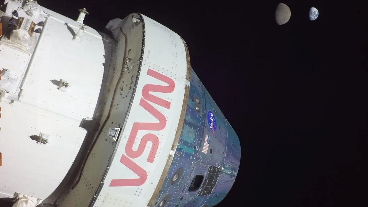 In this file photo, the Orion spacecraft takes a selfie with the moon and Earth in the background. When the Artemis II mission takes place, a human crew will be onboard another Orion capsule and will orbit the moon. (NASA)