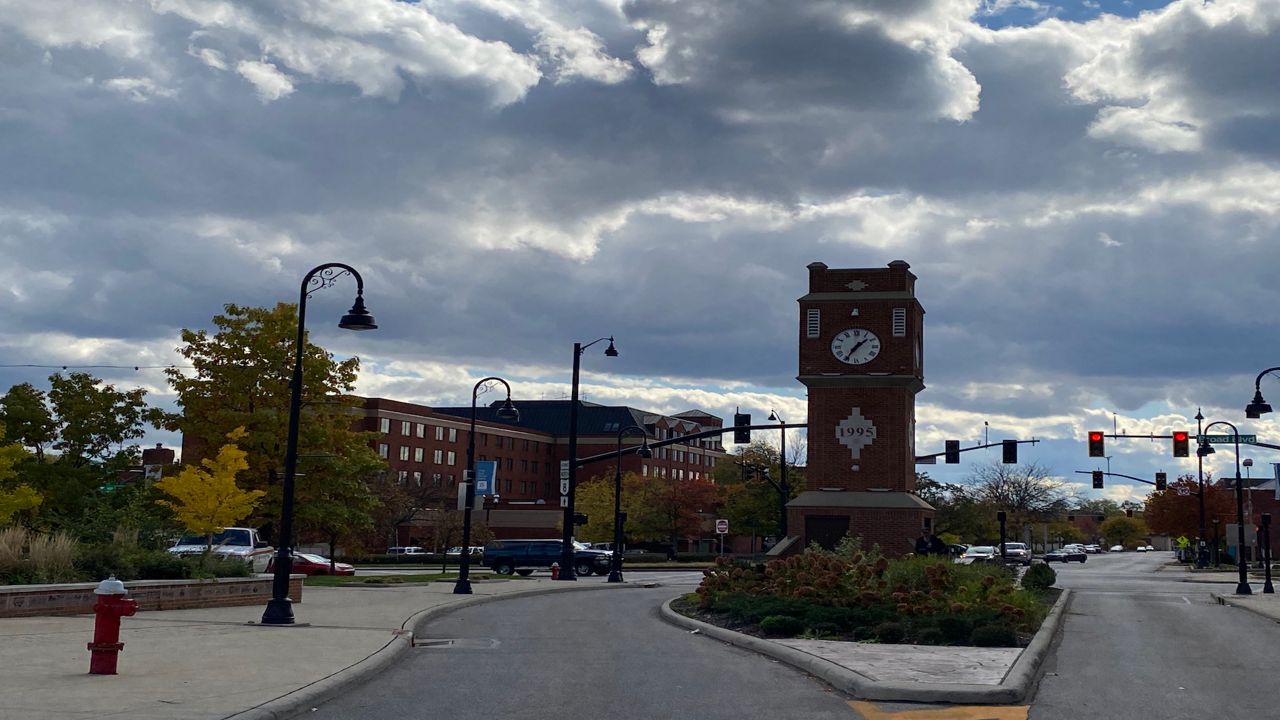 The clock tower at the Cuyahoga Falls riverfront business district against a moody late afternoon sky