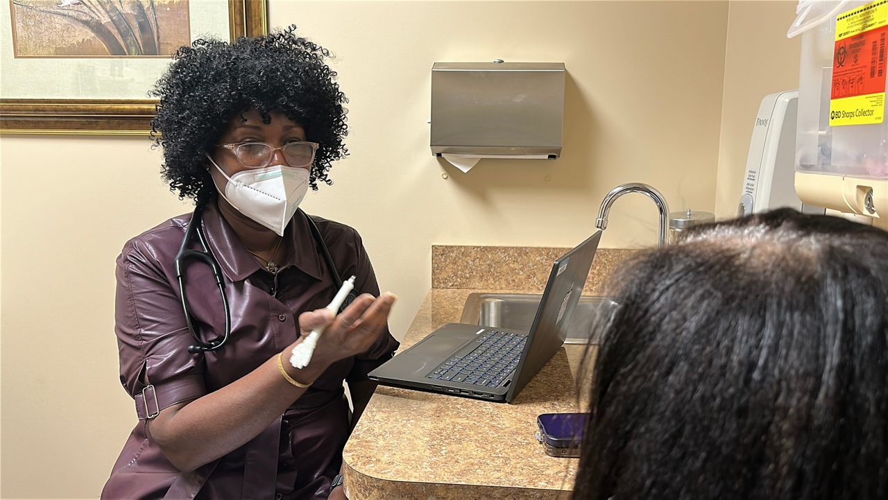 A family nurse practitioner breaks down vitals and more with a patient