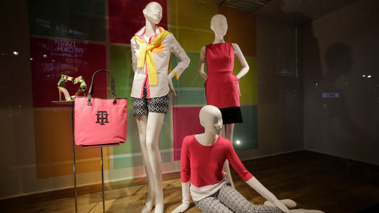 Mannequins displaying warm weather fashions are displayed in a Macy's store window in New York. 