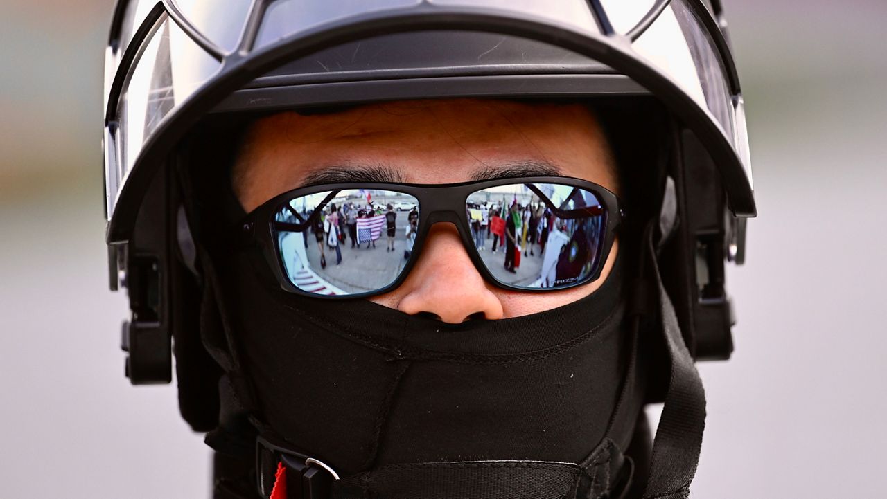 A U.S. Customs and Border Patrol agent looks on during a protest outside the Federal Building on June 13, 2025, in Los Angeles. (AP Photo/Wally Skalij)