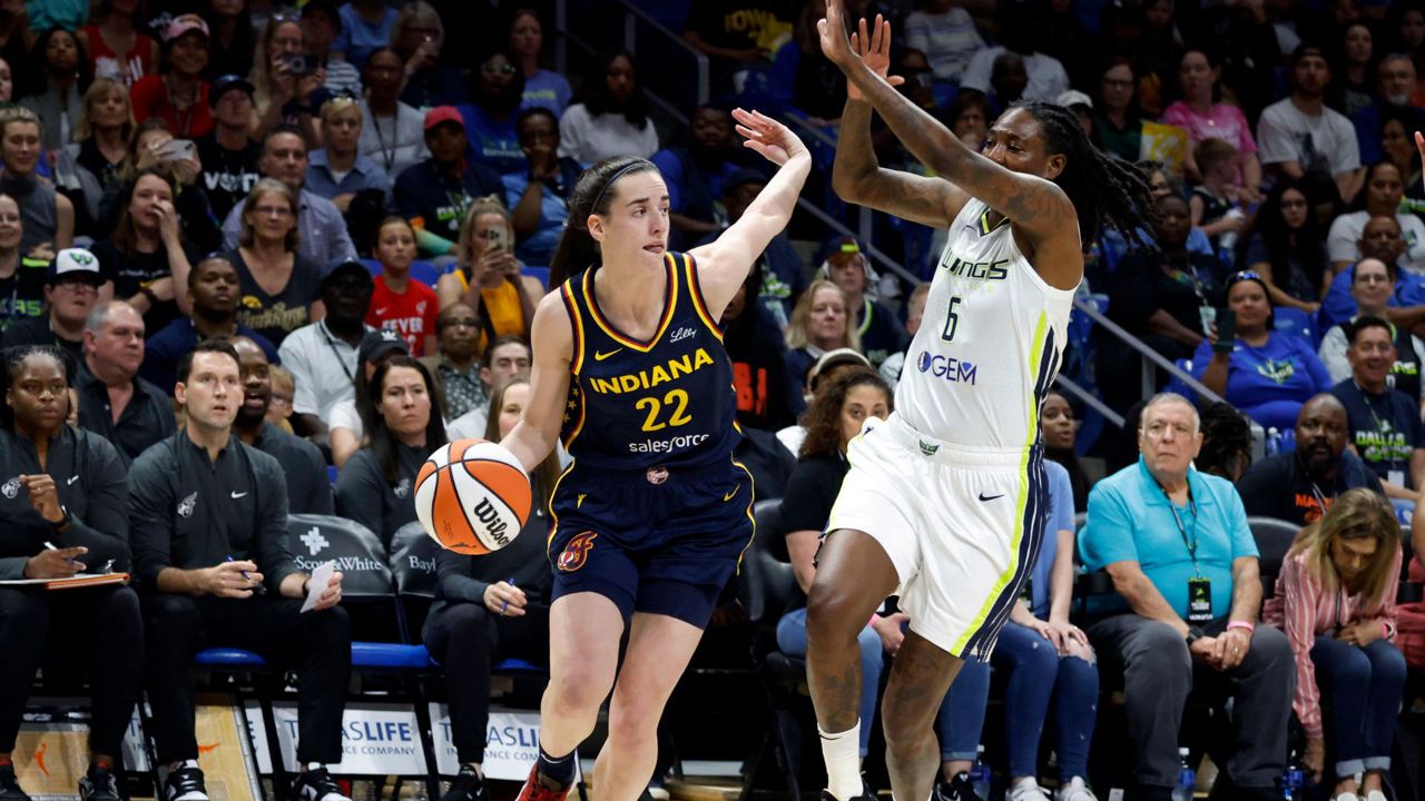 Caitlyn Clark drives past Dallas Wings forward Natasha Howard during the first half of an WNBA basketball game in Arlington on Friday, May 3, 2024.