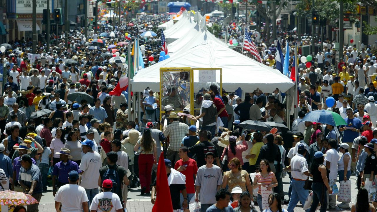 People enjoy the Fiesta Broadway, Sunday, April 25, 2004, in Los Angeles. (AP Photo/Nam Y. Huh)