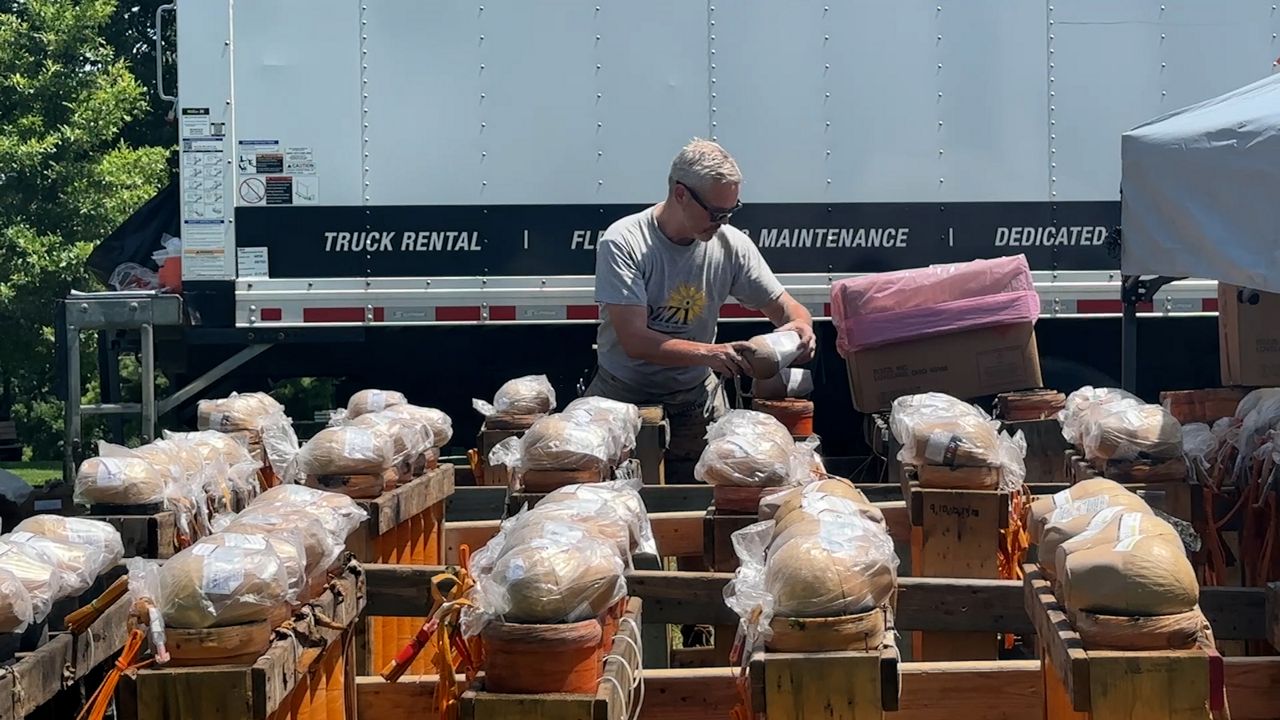 Licensed Firework Exhibitors safely handle fireworks and out them in place ahead of a Fourth of July show (Spectrum News 1/Katie Kapusta)