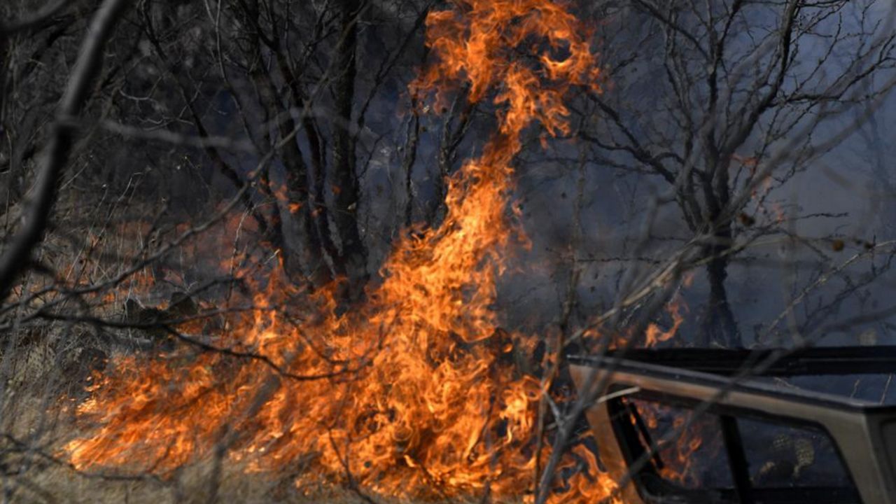 Flames quickly spread through dry grass west of Abilene, Texas near Old Highway 80 Thursday, March 17, 2022. The grass fire quickly spread southeast, jumping the roadway, continuing in the same direction until it jumped South First Street and threatened a mobile home park which was evacuated. (Ronald W. Erdrich/The Abilene Reporter-News via AP)