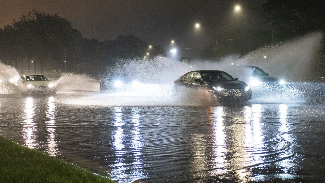 Vehicles make their way through a flooded section of DuSable Lake Shore Drive after a second severe storm raged through Chicago, Monday, July 15, 2024. (Tyler Pasciak LaRiviere/Chicago Sun-Times via AP)