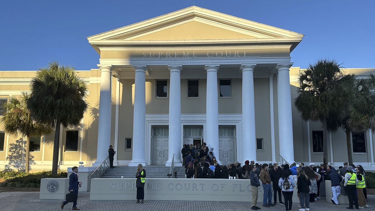 FILE - People gather outside the Florida Supreme Court, Feb. 7, 2024, in Tallahassee, Fla. The recent ruling by the Alabama Supreme Court that frozen embryos can be considered children, halting IVF treatments in the state, is a clear example of why races for state supreme courts will be among the most hotly contested this year. State high court seats will be on the ballot in more than 30 states, and several of those races have the potential to flip political control of the court. (AP Photo/Brendan Farrington, File)