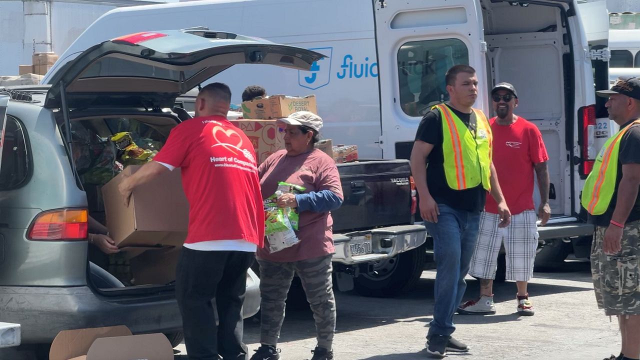 Heart of Compassion volunteers loading cars with donations. (Spectrum News/Shellye Leggett)