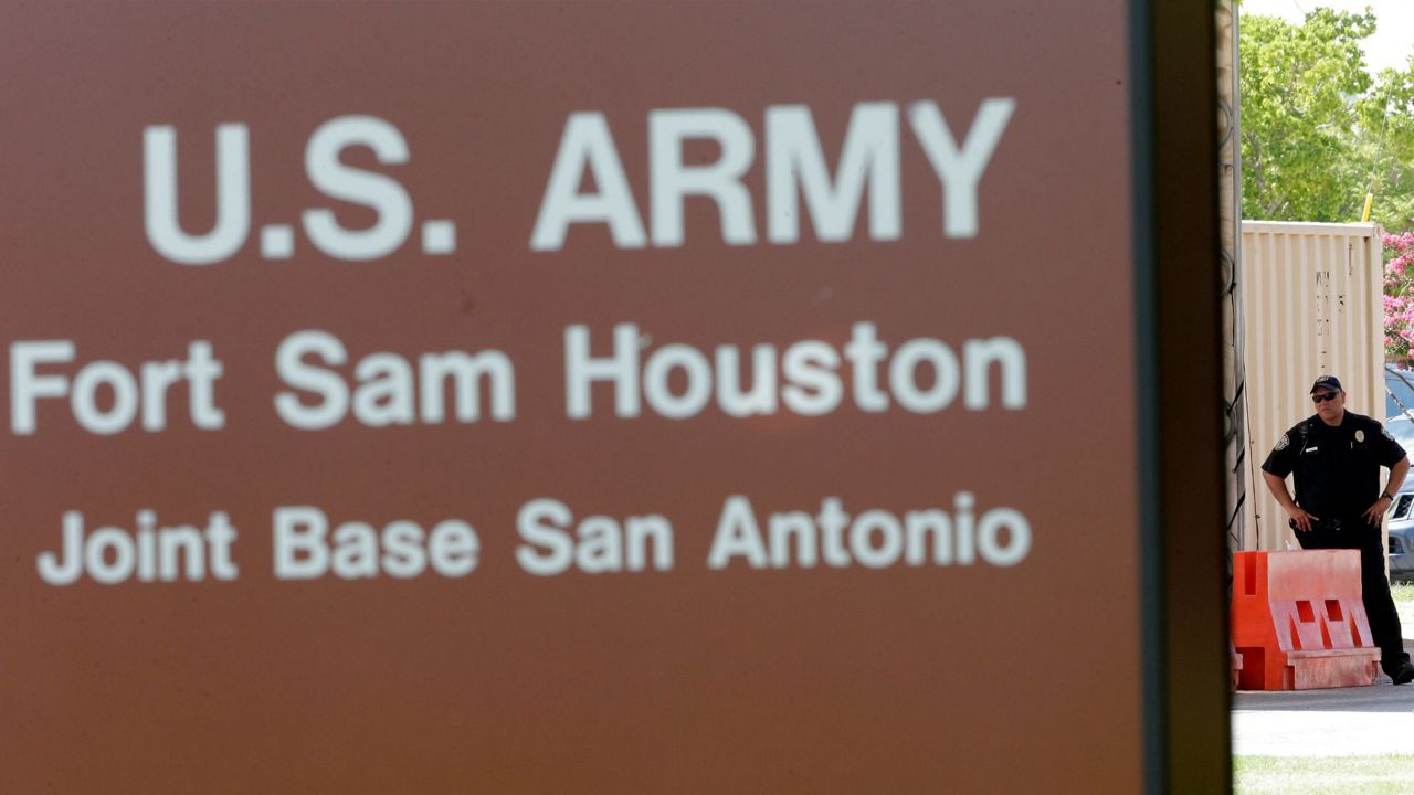 A guard stands at a gate to Fort Sam Houston, Monday, June 10, 2013, in San Antonio. (AP Photo/Eric Gay, File)