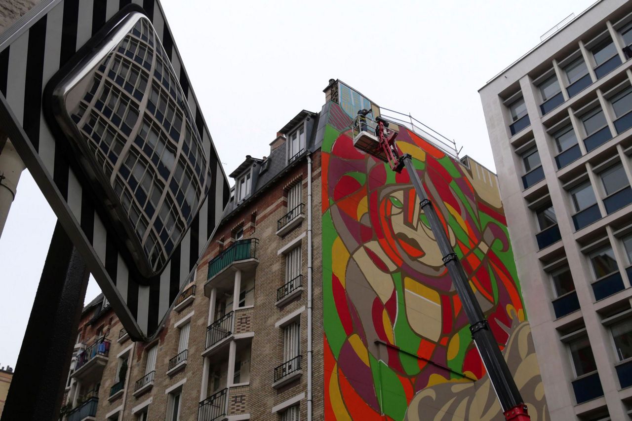 American, French artists revive hope on giant Paris mural