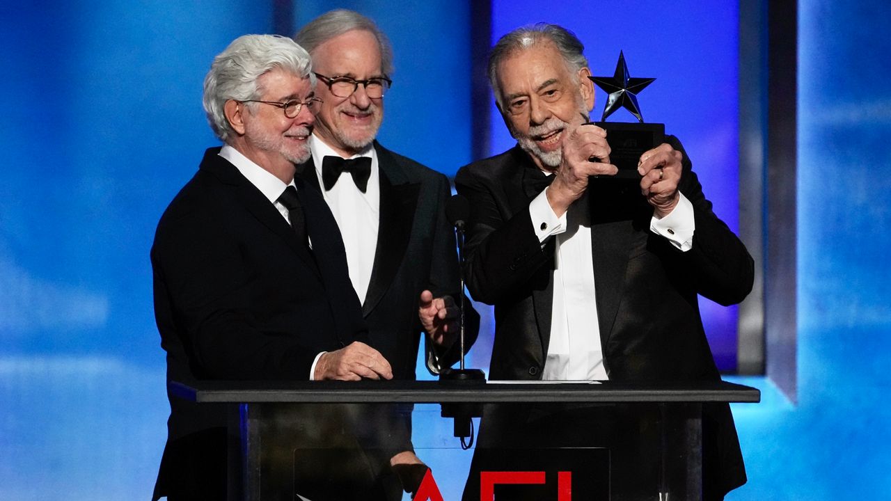 Filmmaker Francis Ford Coppola, right, accepts the 50th AFI Life Achievement Award from presenters George Lucas, left, and Steven Spielberg on Saturday, April 26, 2025, at the Dolby Theatre in Los Angeles. (AP Photo/Chris Pizzello)