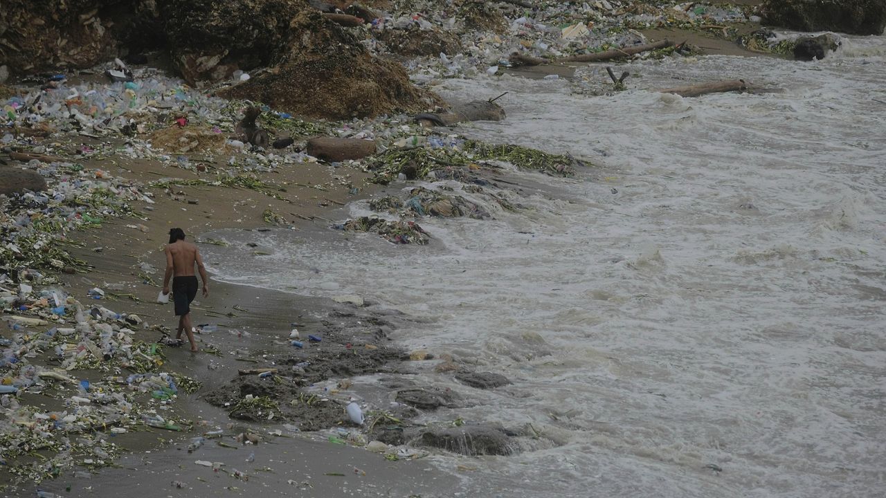 A man walks the sea shore surge caused by Tropical Storm Franklin in Santo Domingo, Dominican Republic, early Wednesday, Aug. 23, 2023. (AP Photo/Ricardo Hernandez)