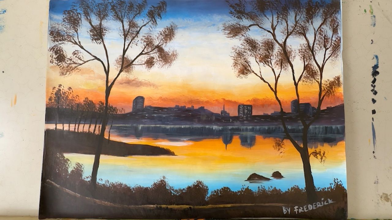 Not all of Ndabaramiye's works are about his native Rwanda. This piece, which he showed off in his Portland studio on Tuesday, shows the city's skyline viewed from the Back Cove Trail (Spectrum News/Sean Murphy)