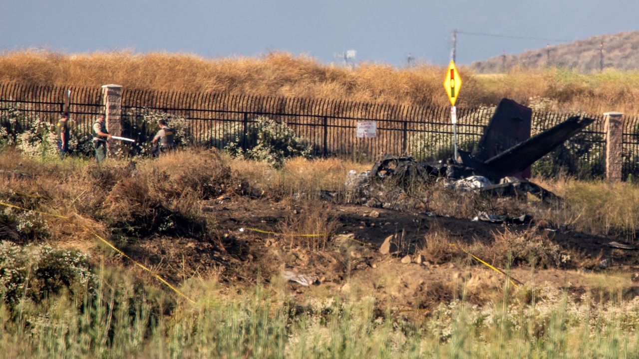 Charred remains of a Cessna lie near the landing approach at French Valley Airport, in Murrieta, Calif., Saturday, July 8, 2023. The Los Angeles Times reports that, according to CalFire, six people died in the crash. (Irfan Khan/Los Angeles Times via AP)