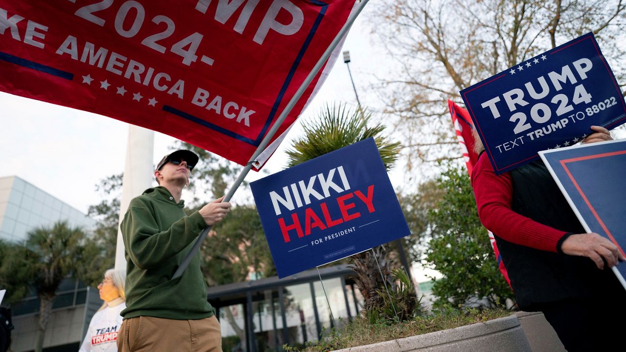 Supporters of Republican presidential candidate former President Donald Trump hold signs outside before a campaign event for Republican presidential candidate former UN Ambassador Nikki Haley at The North Charleston Coliseum, Wednesday, Jan. 24, 2024, in North Charleston, S.C. (AP Photo/Sean Rayford)