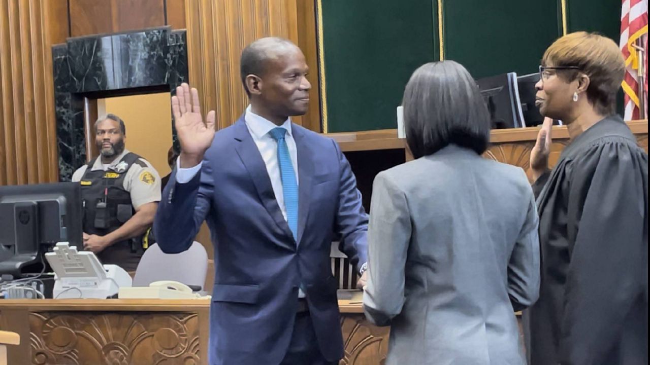 Gabe Gore, left, is sworn in as the new St. Louis Circuit Attorney Tuesday at the Carnahan Courthouse in St. Louis, Mo. (Spectrum News/Gregg Palermo)