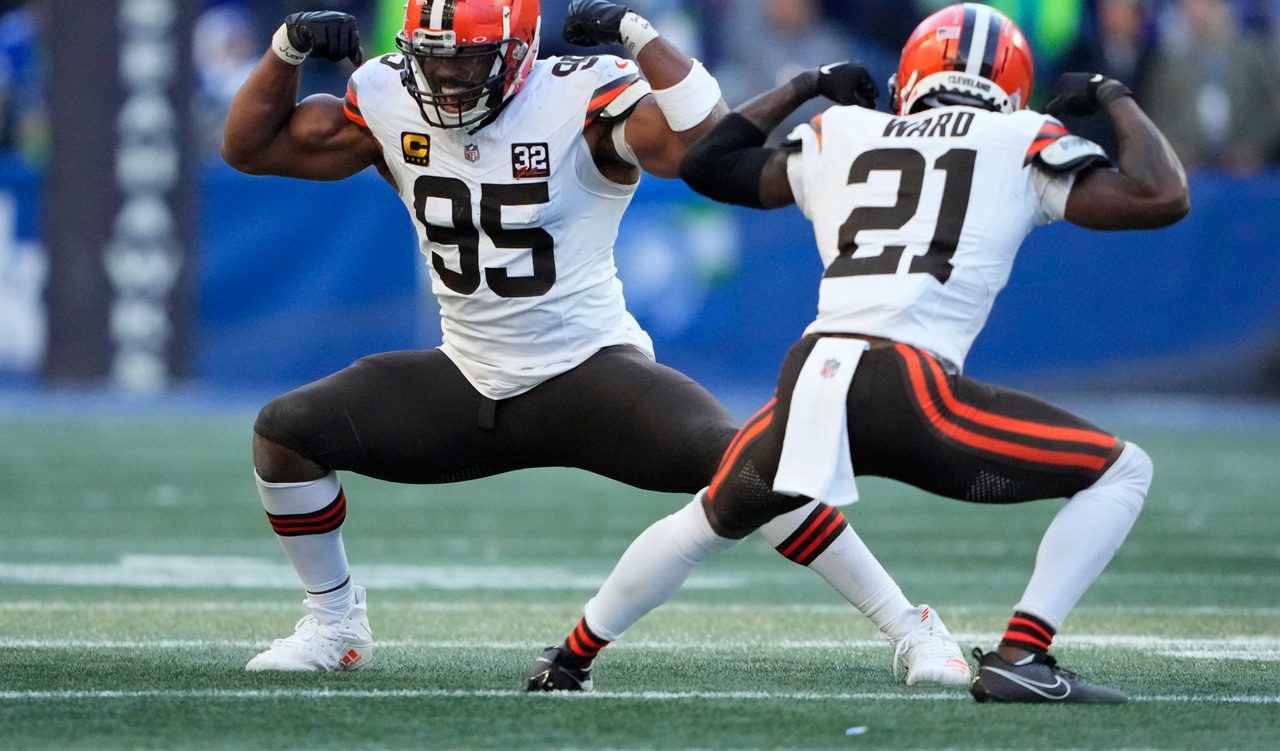 Cleveland Browns defensive end Myles Garrett (95) and cornerback Denzel Ward (21) celebrate a sack by Garrett of Seattle Seahawks quarterback Geno Smith in the second half of an NFL football game, Sunday, Oct. 29, 2023, in Seattle. (AP Photo/Lindsey Wasson)