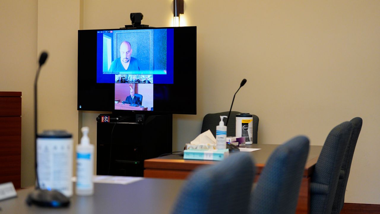 Sean M. Higgins, top, the alleged drunken driver charged with killing NHL hockey player Johnny Gaudreau and his brother Matthew as they bicycled on a rural road, appears before Judge Michael Silvanio, bottom, for his hearing via video from jail, Friday, Sept. 13, 2024, in Woodbury, N.J. 