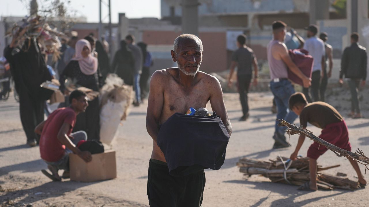 Palestinians carry boxes containing food and humanitarian aid packages delivered by the Gaza Humanitarian Foundation, a U.S.-backed organization approved by Israel, in Rafah, southern Gaza Strip, on Tuesday, May 27, 2025. (AP Photo/Abdel Kareem Hana)