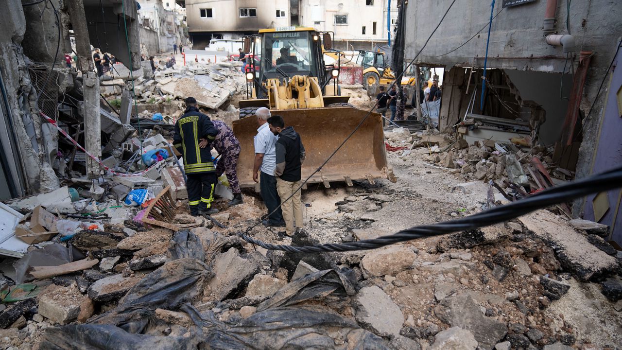 Palestinian municipality workers clear the rubble in the West Bank refugee camp of Nur Shams on Sunday, April 21, 2024.