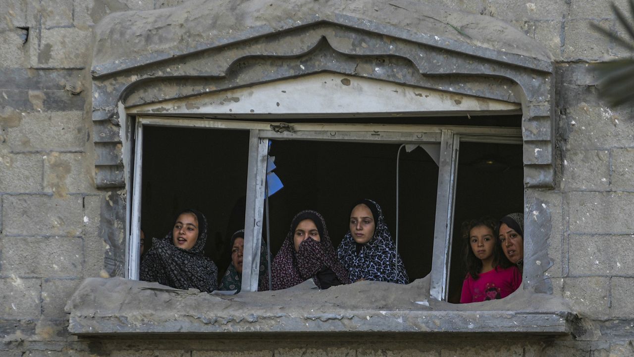 Palestinians look at the destruction after an Israeli airstrike on a crowded tent camp housing Palestinians displaced by the war in Muwasi, Gaza Strip, Tuesday, Sept. 10, 2024. (AP Photo/Abdel Kareem Hana)