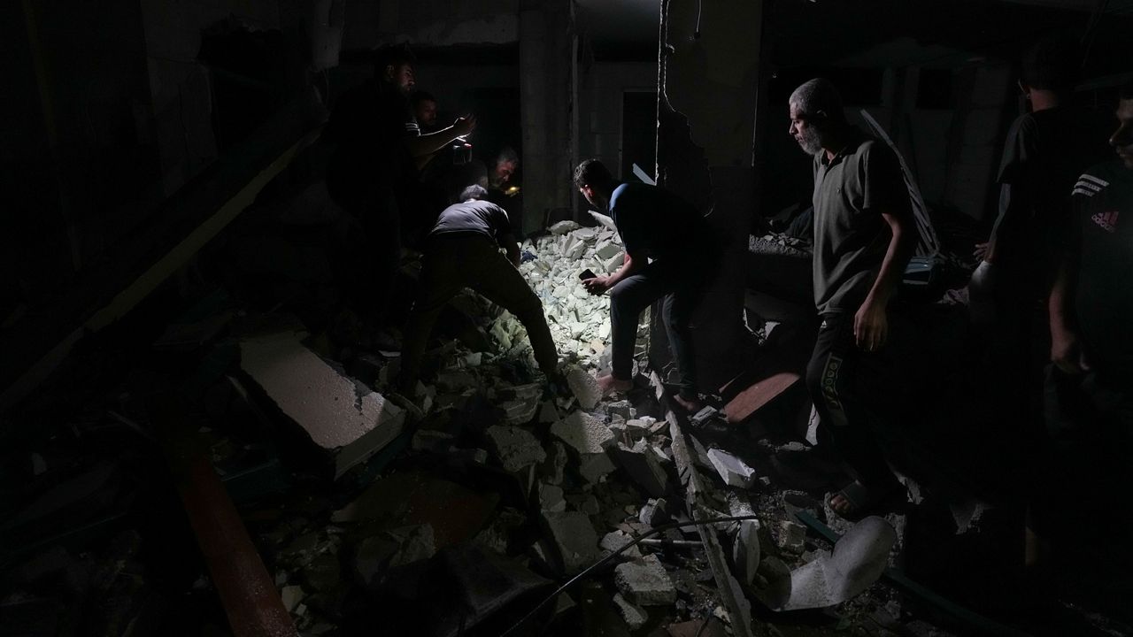 Palestinians search for survivors and bodies in the rubble of a mosque destroyed in an Israeli airstrike in Deir al-Balah, Sunday, Oct. 6, 2024. (AP Photo/Abdel Kareem Hana)