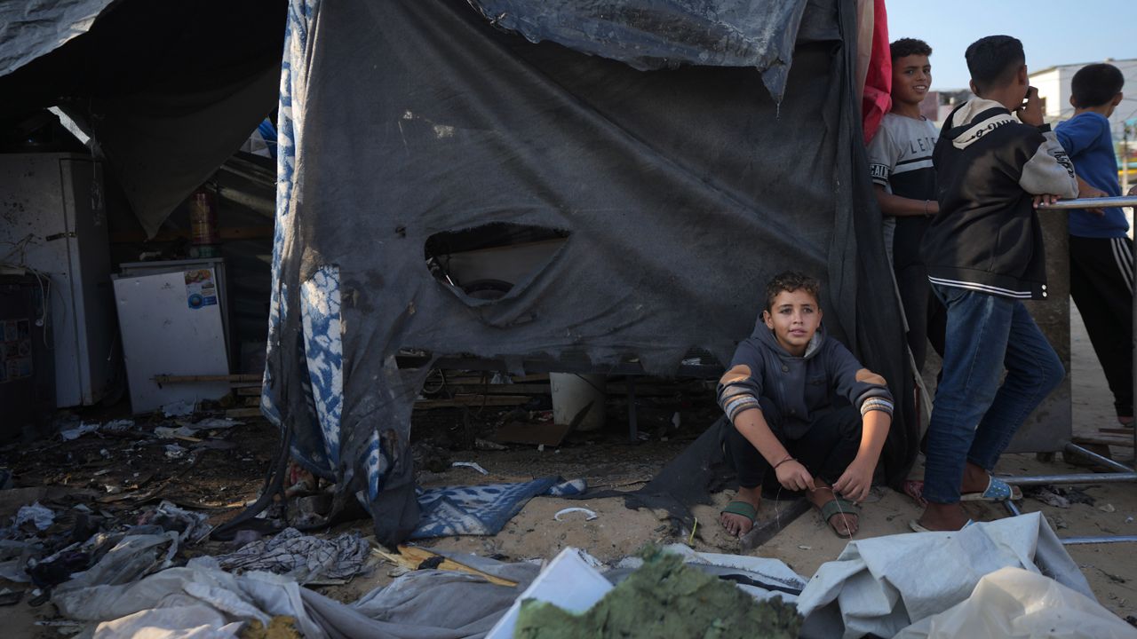 Palestinians gather at the site of an Israeli strike in the courtyard of the Al-Aqsa Hospital where displaced people live in tents, in Deir al-Balah, Gaza Strip, Saturday, Nov. 9, 2024. (AP Photo/Abdel Kareem Hana)