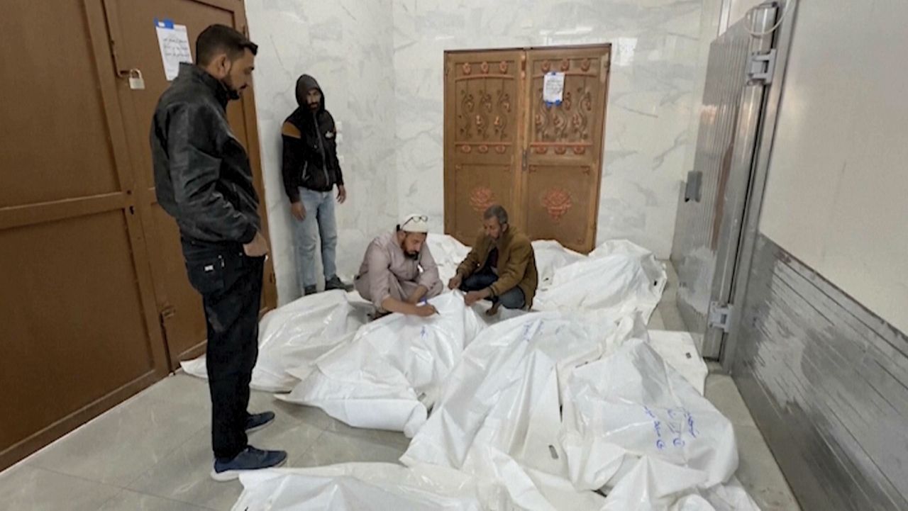 Palestinians gather in a morgue with the bodies of their relatives killed in Israeli airstrikes in the city of Khan Younis, southern Gaza Strip, Friday, Oct. 25, 2024. (AP Photo)