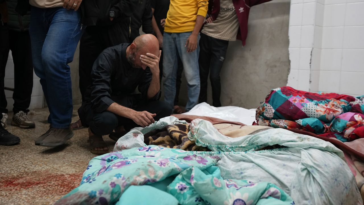 Palestinians mourn over relatives killed in an Israeli bombardment in Nuseirat, central Gaza, as they stand in a hospital morgue in Deir al-Balah, Gaza Strip, Wednesday, Nov. 20, 2024. (AP Photo/Abdel Kareem Hana)