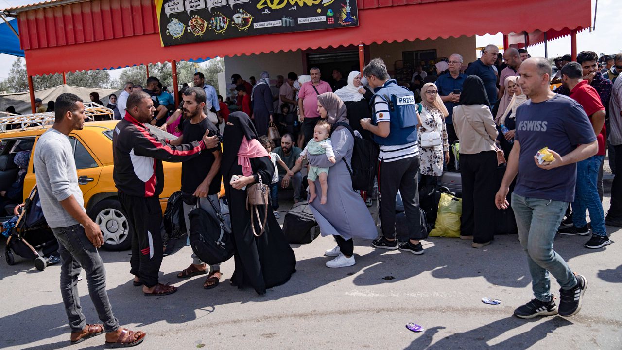 Palestinians wait to cross into Egypt at the Rafah border crossing in the Gaza Strip, Oct. 16, 2023. Former President Donald Trump and other top Republicans are issuing increasingly urgent calls for the U.S. to seal its borders against a potential mass exodus of Palestinians fleeing war in the Gaza Strip, suggesting that a surge in civilian refugees could allow potential extremists into the country. (AP Photo/Fatima Shbair, File)