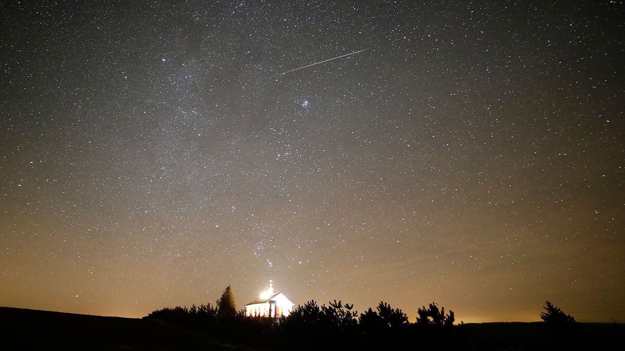 A meteor streaks across the sky during the annual Geminids meteor shower over an Orthodox church on the local cemetery near the village of Zagorie, some 110 km ( 69 miles) west of capital Minsk, Belarus, late Wednesday, Dec. 13, 2017. (AP Photo/Sergei Grits)