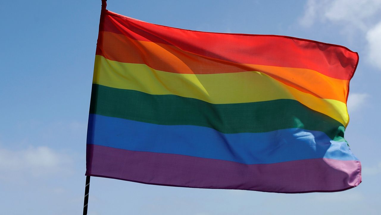 A rainbow flag set up by Ronnie Alvarez, lead designer of Balloon Magic, flies over the skyline at Dolores Park in San Francisco, Sunday, June 28, 2020. (AP Photo/Jeff Chiu)